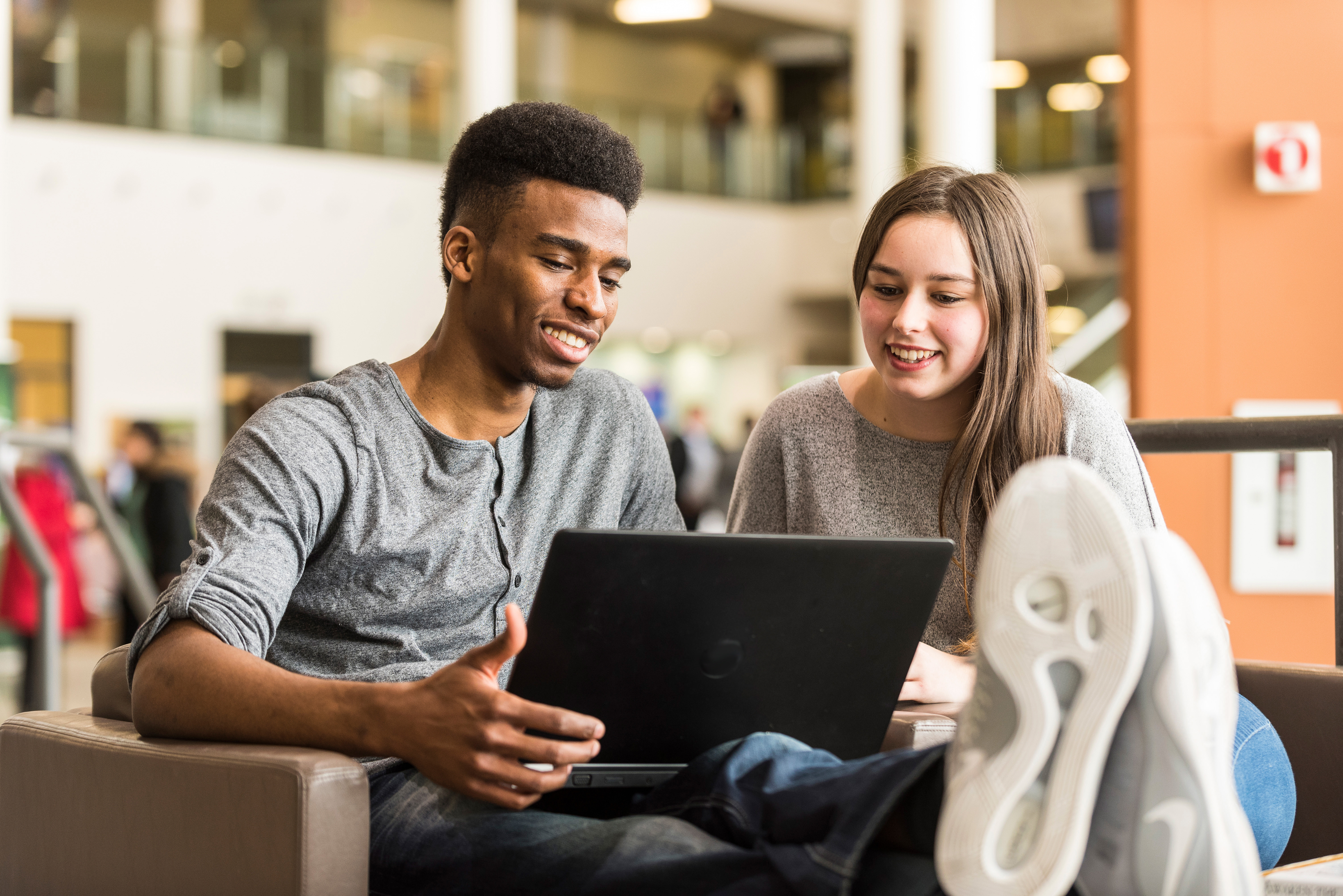 Picture of Algonquin College students looking at a computer.